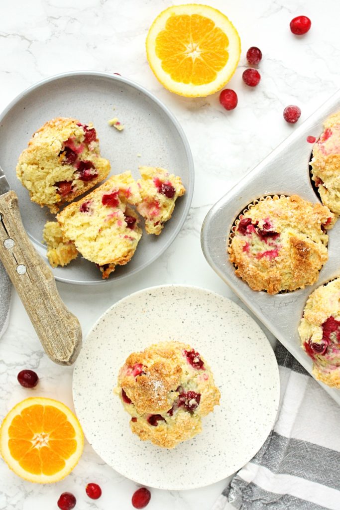 The Best Orange Cranberry Muffins || A perfect blend of sweet orange, vanilla flavor and cranberry tartness, packed into a wonderfully dense, chewy, crispy-topped muffin. Made with the zest of one navel orange, frozen cranberries, melted butter, and sour cream. #mondaysundaykitchen #orangecranberrymuffins #bestorangecranberrymuffinsrecipe #bestmuffinrecipes #orangemuffins #cranberrymuffins #cranberryrecipes #orangerecipes #muffinrecipes 