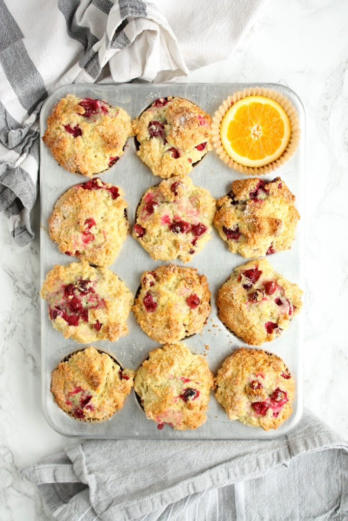 The Best Orange Cranberry Muffins || A perfect blend of sweet orange, vanilla flavor and cranberry tartness, packed into a wonderfully dense, chewy, crispy-topped muffin. Made with the zest of one navel orange, frozen cranberries, melted butter, and sour cream. #mondaysundaykitchen #orangecranberrymuffins #bestorangecranberrymuffinsrecipe #bestmuffinrecipes #orangemuffins #cranberrymuffins #cranberryrecipes #orangerecipes #muffinrecipes 