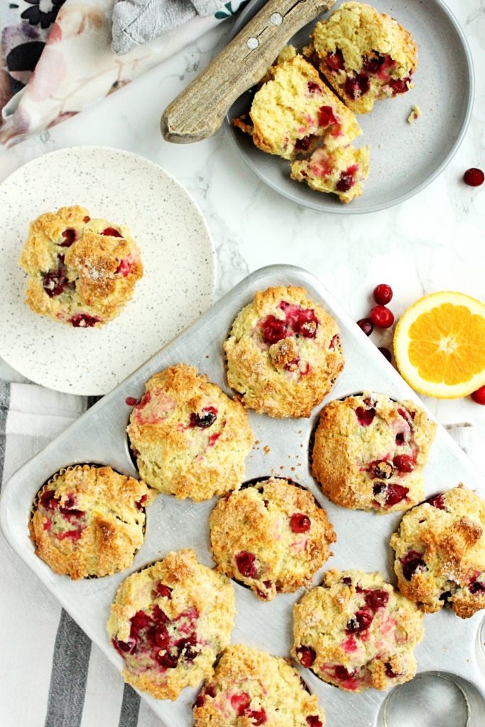 The Best Orange Cranberry Muffins || A perfect blend of sweet orange, vanilla flavor and cranberry tartness, packed into a wonderfully dense, chewy, crispy-topped muffin. Made with the zest of one navel orange, frozen cranberries, melted butter, and sour cream. #mondaysundaykitchen #orangecranberrymuffins #bestorangecranberrymuffinsrecipe #bestmuffinrecipes #orangemuffins #cranberrymuffins #cranberryrecipes #orangerecipes #muffinrecipes 