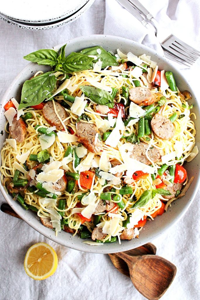 Grilled Italian sausages, red peppers, fresh basil, garden beans, and parmesan tossed with pasta and a light, bright lemon and olive oil dressing.