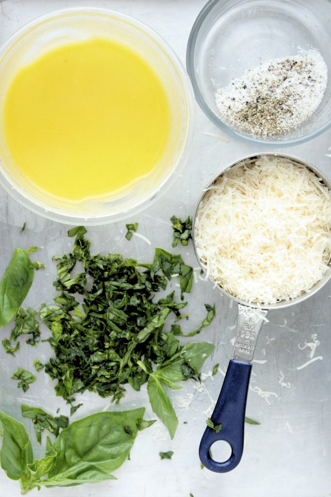 Pasta ingredients: fresh basil, grated parmesan, salt, pepper, and a lemon and olive oil dressing.