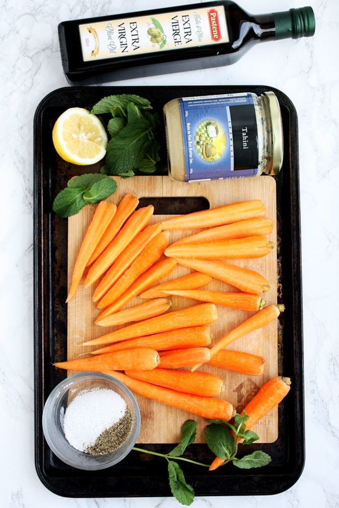 Ingredients to make oven roasted carrots with tahini dressing.