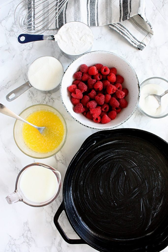 Cobbler ingredients: self-rising flour, sugar, milk, butter, and fresh raspberries.