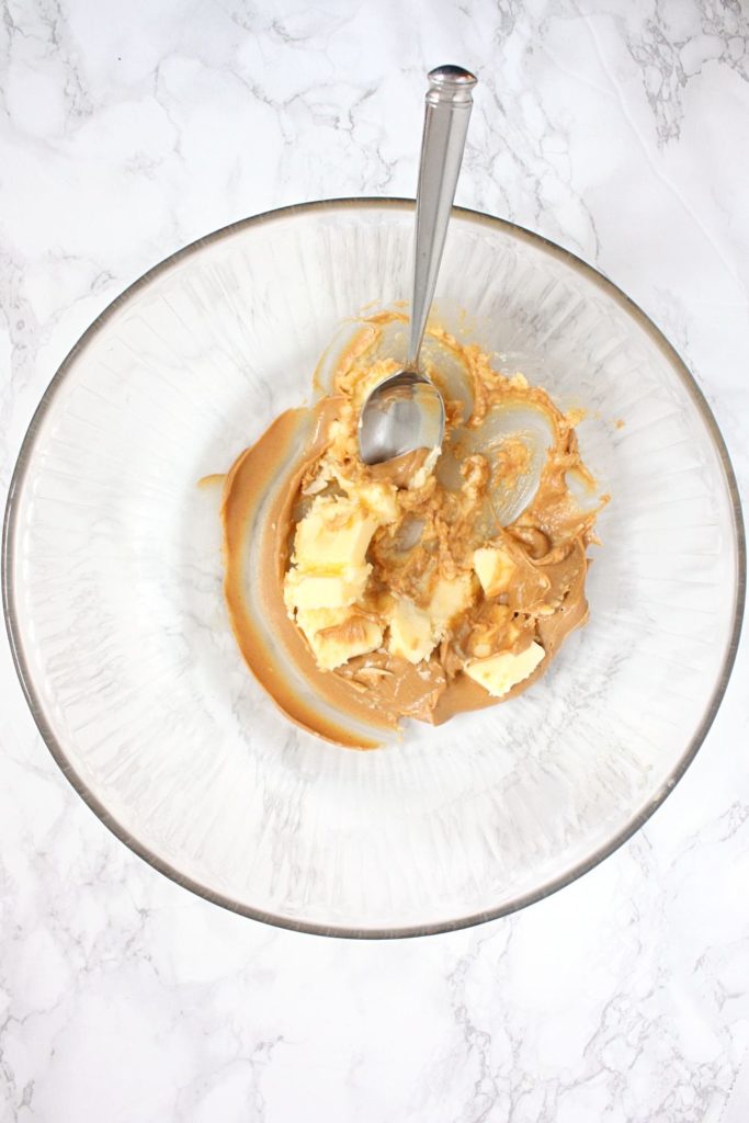 Creaming peanut butter and butter in a mixing bowl.