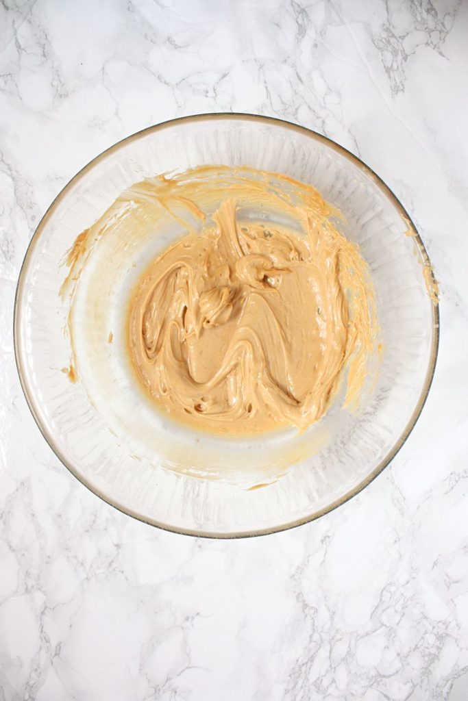 Peanut butter and butter creamed until smooth in a mixing bowl.