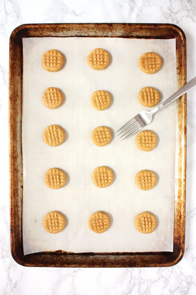 How to flatten cookies with a fork before baking.