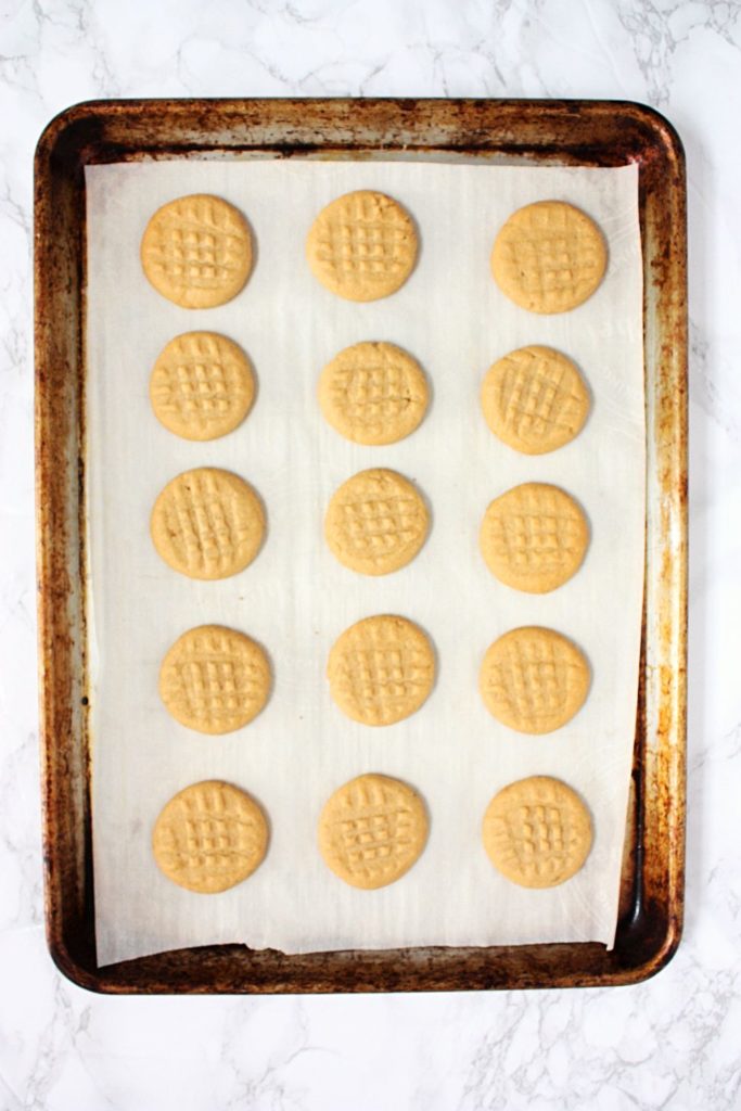 Peanut Butter Shortbread Cookies fresh out of the oven on a baking tray.