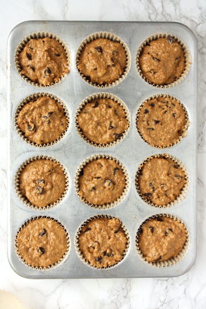 Muffins tins filled with bran muffin batter, ready to be baked.