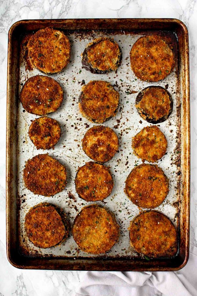 Crispy baked eggplant slices on a baking sheet